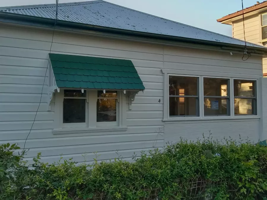 Restored timber house exterior after preparation and painting