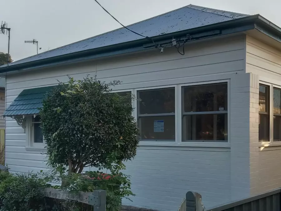 Front corner of timber house after exterior restoration and painting