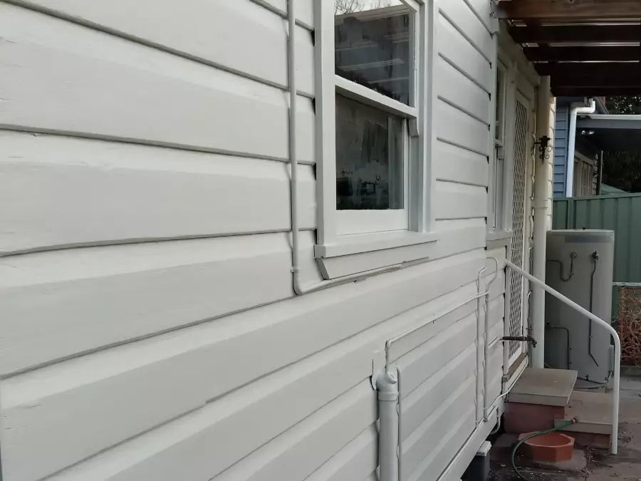 Timber wall and window after exterior preparation and painting